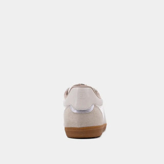 Beige shoe with a brown sole on a white background