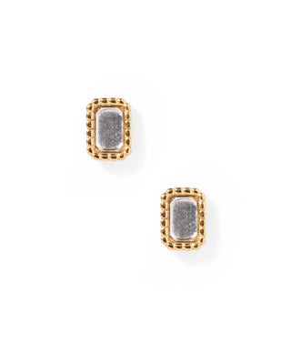 Pair of gold earrings with textured centers on a white background