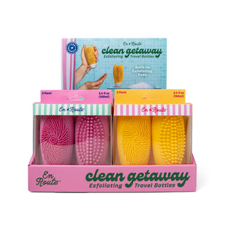 Packaging of 'En Route' clean getaway exfoliating travel bottles in pink and yellow.