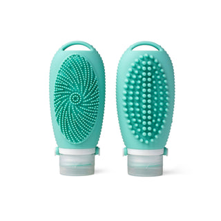 Two turquoise silicone scrubbing brushes on a white background