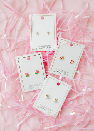 Set of earrings on LINNY CO cards with pink shredded paper background