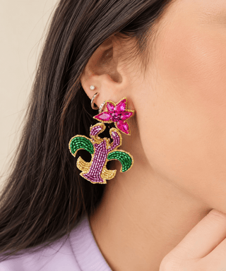 Beaded Mardi Craw dangle earring in pink, green, purple and gold, worn by model