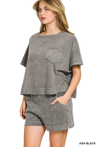 Woman wearing a gray oversized t-shirt and shorts set on a white background