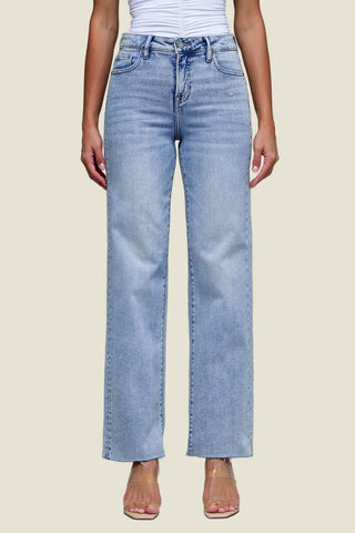 Light blue jeans worn by a person on a gray background