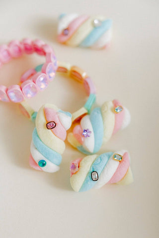 Colorful hair ties with decorative beads on a light background