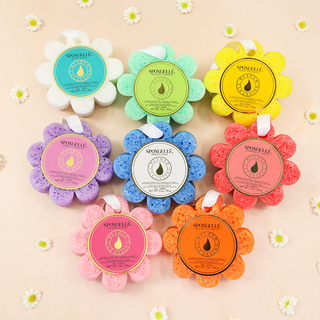 Colorful flower-shaped sponges with brand labels on a light background