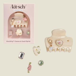 Kitsch hair clip set with decorative charms on a white background
