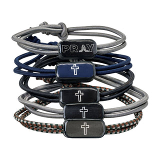 Set of braided bracelets with prayer and cross charms on a white background