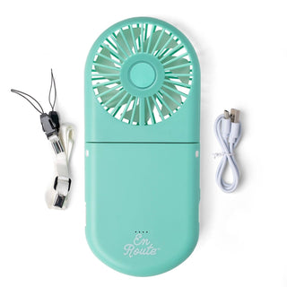 Turquoise handheld fan with charging cable on a white background