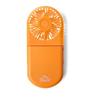 Orange handheld fan with 'En Route' text on a white background