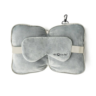 Gray travel pillow and eye mask set with 'enRoute' branding on a white background
