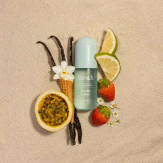 Kitsch product with vanilla beans, lemon slices, strawberries, and a flower on a beige background