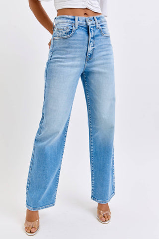 Light blue jeans worn by a person on a white background