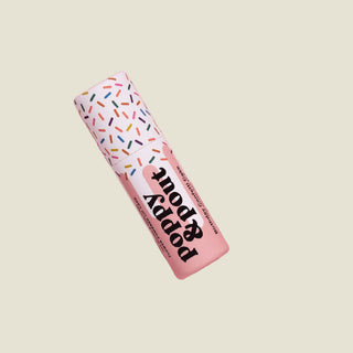 Puppy Pop toy with colorful packaging on a pink background