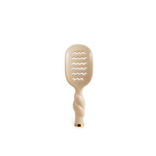 A single beige hairbrush with a wavy slotted head and a twisted handle, centered on a plain white background.