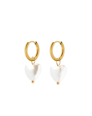 Gold hoop earrings with white heart-shaped charms on a white background