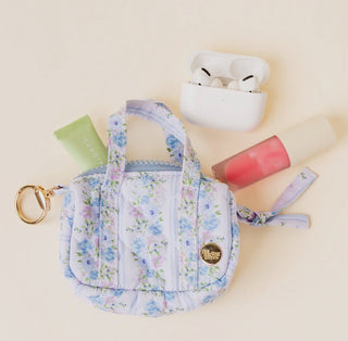 Itty Bitty Duffle Bag Charm in Petal Parade Blue shown with small essentials for size