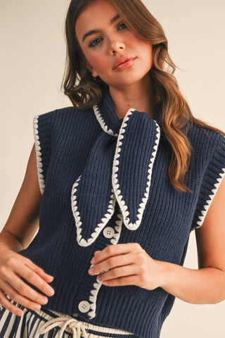 Tie neck button-down sweater vest with contrast blanket stitch