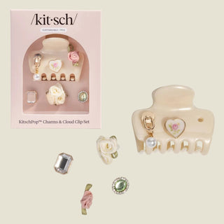 Kitsch hair clip set with decorative charms on a white background