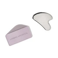 Lemon Lavender Oh My Gua Sha stainless steel facial tool with purple travel sleeve