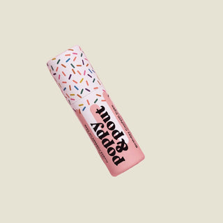 Puppy Pop toy with colorful packaging on a pink background