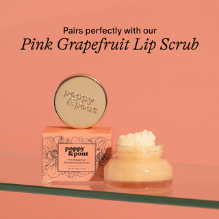 Pink Grapefruit Lip Scrub packaging with a jar of scrub on a peach background