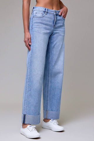 Light blue jeans worn by a person on a plain background