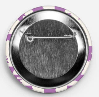 Button badge with a safety pin design on a white background