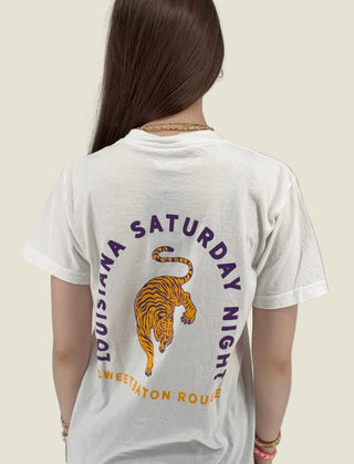 Person wearing a white t-shirt with a tiger graphic and text on the back, against a plain background.