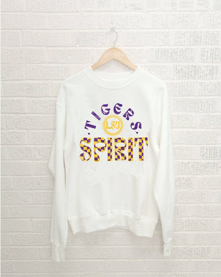 White sweatshirt with 'Tigers Spirit' text on a white brick wall background