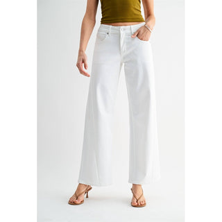 Person wearing white wide-leg jeans on a plain background