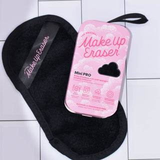 Make Up Eraser Mini Pro with black cleaning cloth on a tiled surface