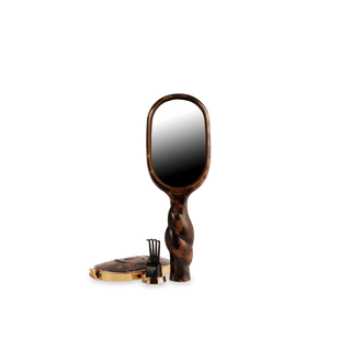 Tortoiseshell hand mirror with a black center on a white background
