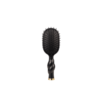 Black hairbrush with gold accent on a white background