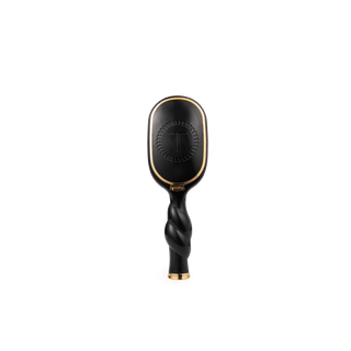 Black hairbrush with gold accents on a white background