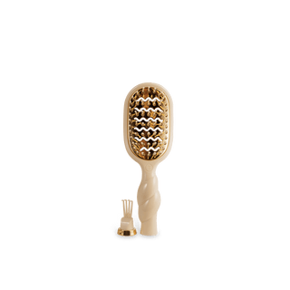 Beige paddle hair brush with gold bristle head on a white background