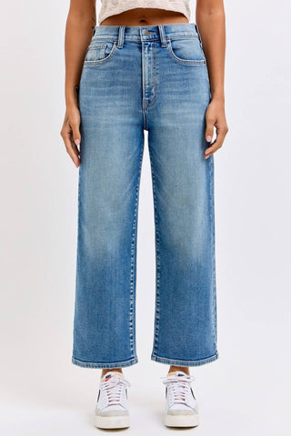 Person wearing blue jeans on a white background