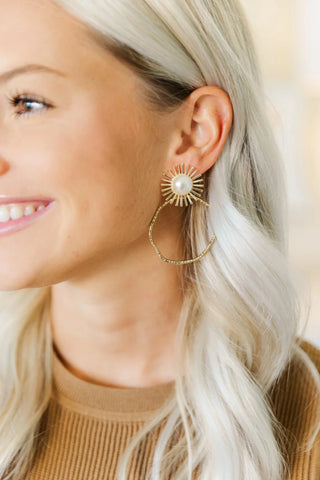 Pearl Sunburst Hoop in gold with pearl center, worn by model