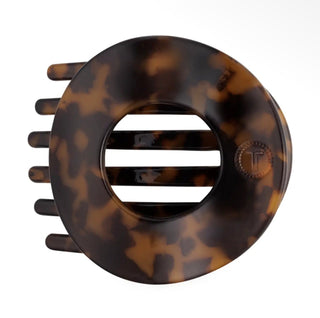A large tortoiseshell hair claw comb with a circular design, featuring a glossy dark brown and amber pattern, shown on a plain white background.