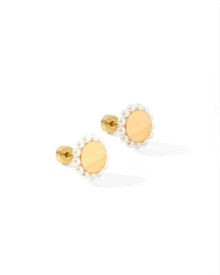 Gold earrings with pearl-like centers on a white background