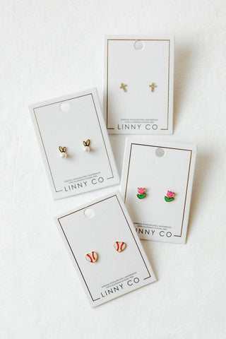 Set of earrings on LINNY CO branded cards against a white background