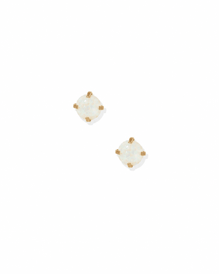 Pair of gold stud earrings with clear gemstones on a white background