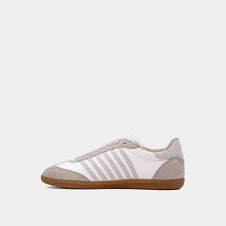 White and gray sneaker with three stripes on a light gray background