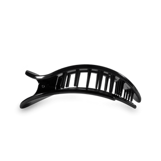 Black flat hair clip with teleties logo on a white background