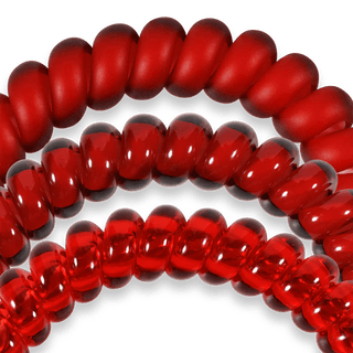 Close-up of red glass beads on a white background