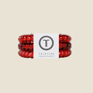 Red hair ties with a white label on a white background