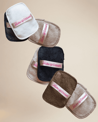 Makeup eraser pads in various colors on a beige background