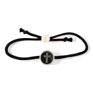 Black cord bracelet with cross charm on a white background