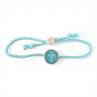 Turquoise braided bracelet with a cross charm on a white background