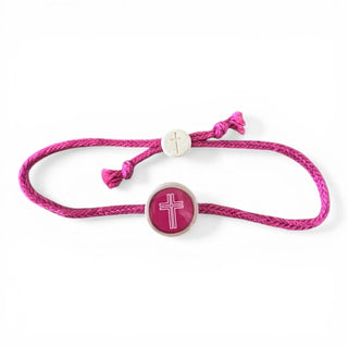 Pink bracelet with a cross charm on a white background